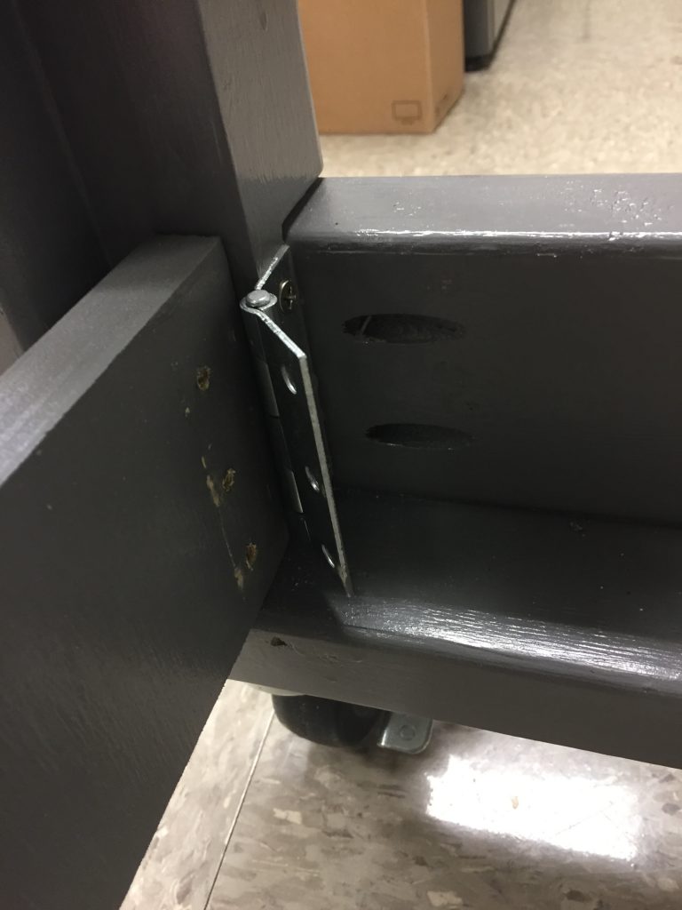 A hinge on the cart coming free