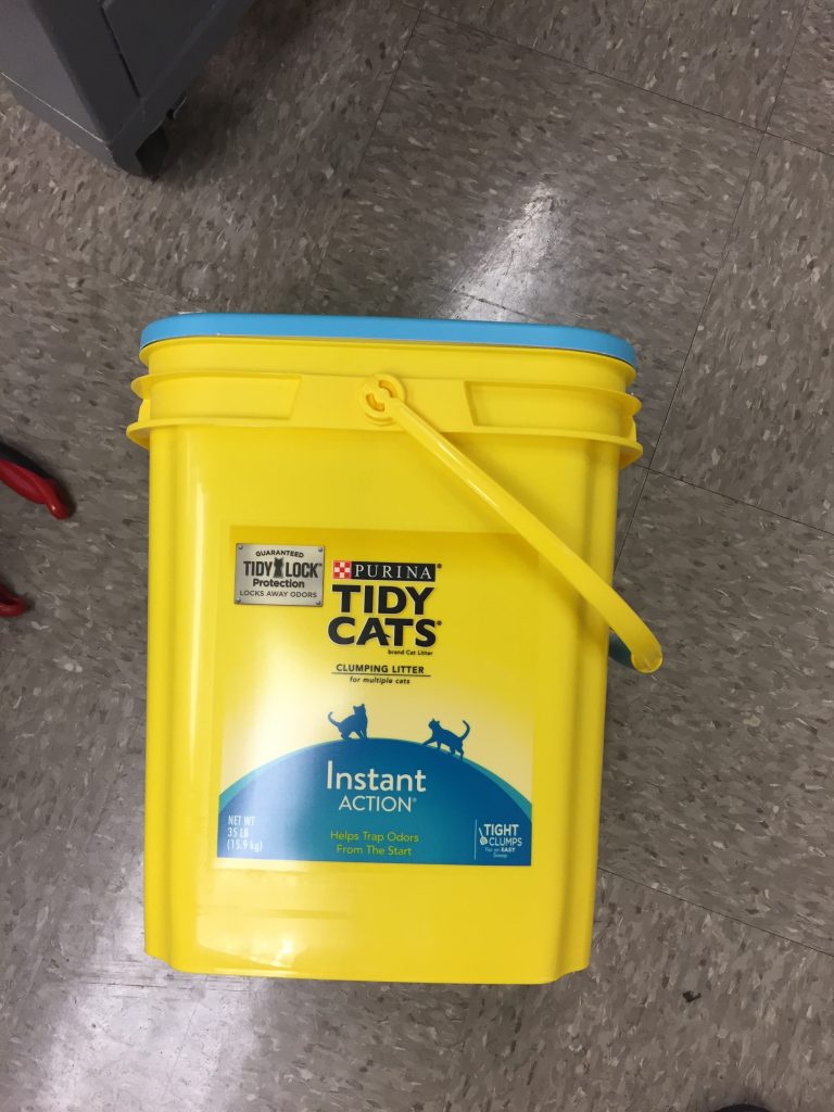 A yellow cat litter container