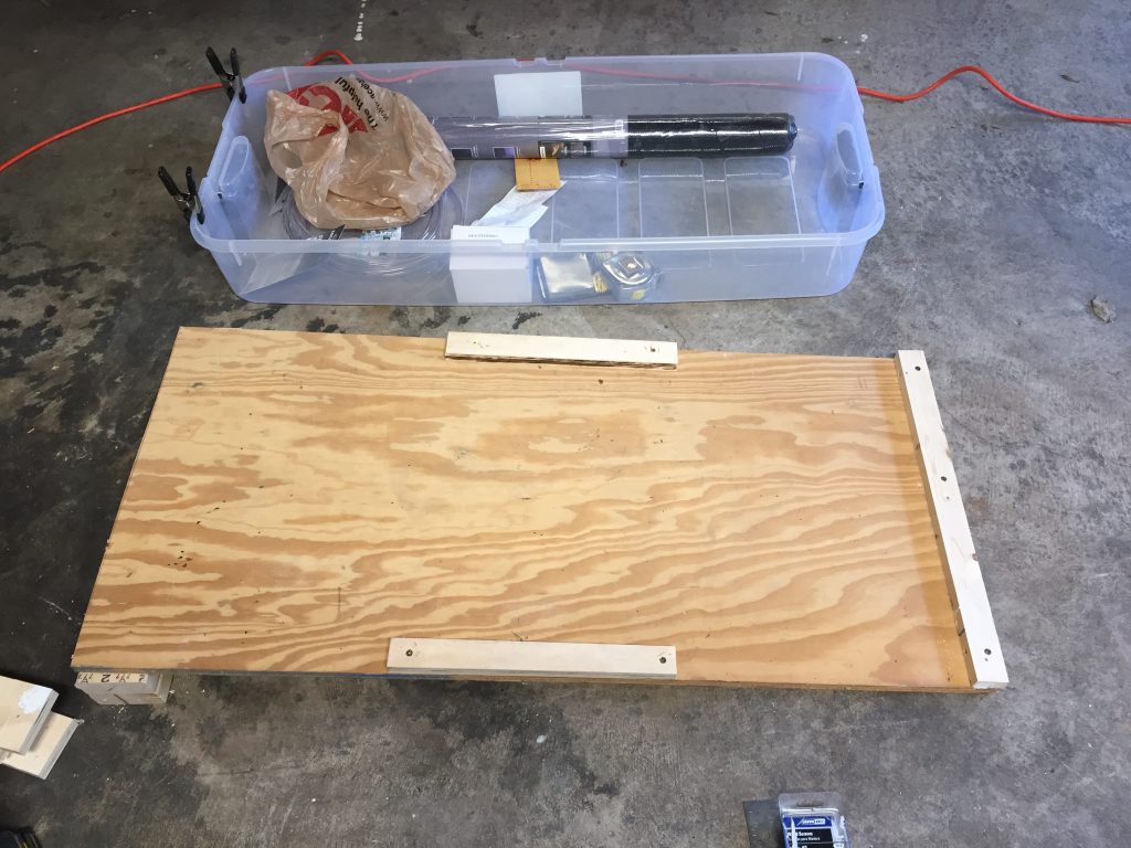 Building materials next to a rectangle piece of wood